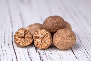 Nutmeg on the wooden background