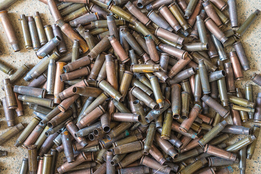 Heap Of Old Used Bullet Shells On The Stone Background