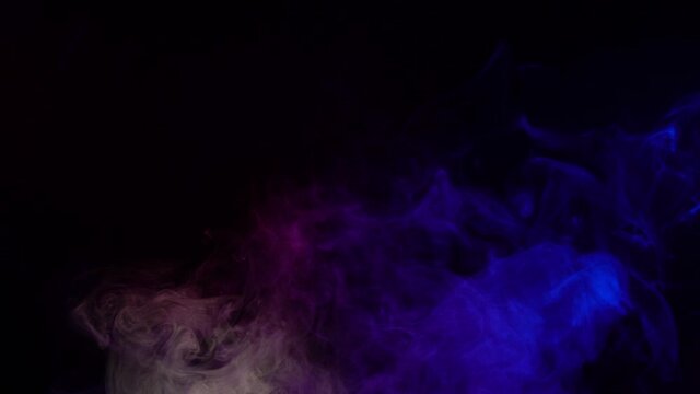 Smoke on a black background. Bright colorful smoke. Blue, raspberry, red, purple background. Beautiful abstract background. smoke texture. Pattern.