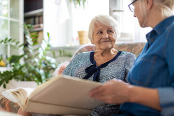 Granny showing her daughter memories from past
