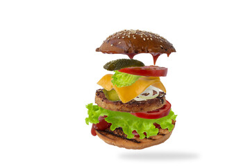 Delicious burger with flying ingredients isolated on white background. Food levitation concept.