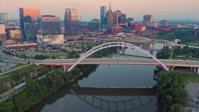 Aerial: Traffic Over The Korean Veterans Memorial Bridge & Downtown Nashville At Sunrise. Tennessee, USA