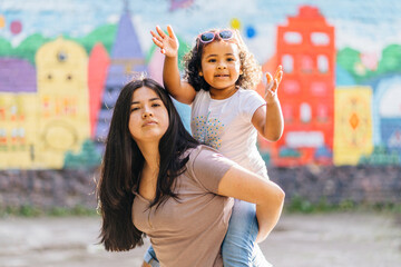 Happy family piggyback. Parenthood, childhood, love and happiness concept. Single mixed race mother...