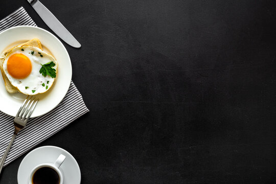 Fried Eggs Sandwich On Plate - Black Desk Top View Copy Space