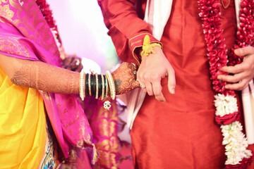 Fototapeta na wymiar In Indian traditional wedding couple holding hand
