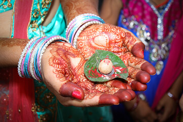 Indian hindu bride applied henna on hand and carry betel leaf and betel nut 