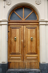 elegant wooden door with golden knockers