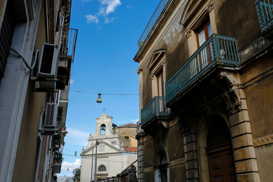 narrow street and church Chiesa dell'Addolorata in Riposto, Giarre, Sicily, Italy