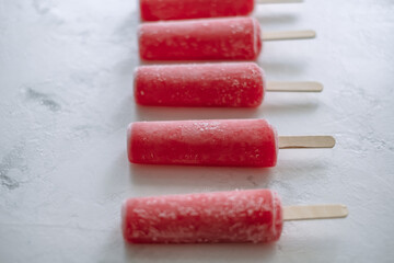 Pink fruit ice sorbet on a white background. Stick ice cream. Close up