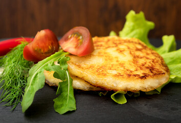 Grilled cheese with vegetables on the plate.