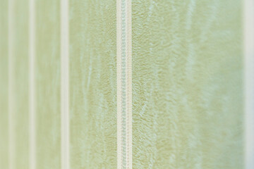 The light green Wallpaper with white stripes is taken at an angle