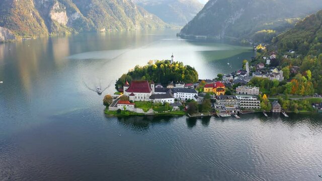 4k point of view video (Ultra High Definition). Picturesque morning view of Maria Kronung church. Aerial autumn scene of Traunsee lake. Stunnig landscape of Austrian Alps.