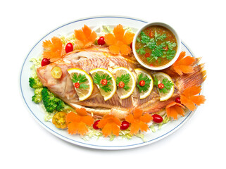 Steamed fish (Tilapia fish) in lemon sauce with Thai spicy sauce