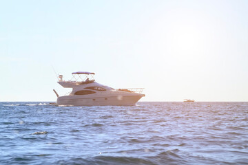 people sunbathe on a white yacht in the open sea