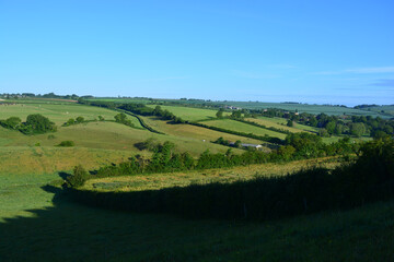 Looking over green pasture fields and valley towards Poyntington from the hiking route known as Donkey Lane trail, Sherborne, Dorset, England.