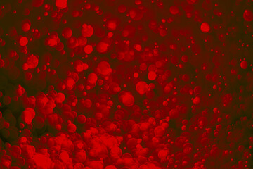 Red glitter vintage lights background. Red bokeh on black background.