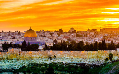 Fototapeta premium Dramatic sunset view of the ancient cemetery at the Golden Gate, Dome of the Rock on the Temple Mount, with Hurva synagogue, Old City buildings and West Jerusalem hotels, including King David Hotel