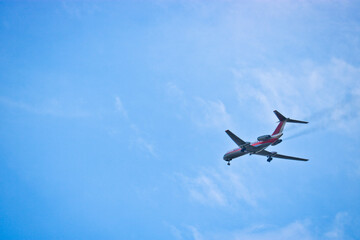 Passenger airliner flying in the blue sky. The concept of vacation, business trip, dream. Commercial aircraft.
