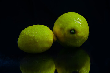 Fototapeta na wymiar fresh sweet yellow lemon isolated on black background
