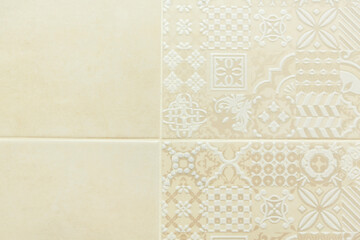 White ceramic tile on the wall with a beautiful floral beige pattern