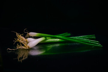 Fototapeta na wymiar fresh green onion isolated on black background