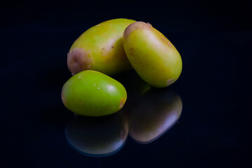 fresh new potatoes isolated on black background