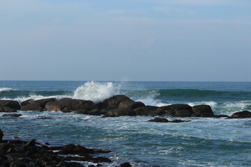 Fototapeta na wymiar Sea White water waves jumping over the Rocks at Indian Ocean
