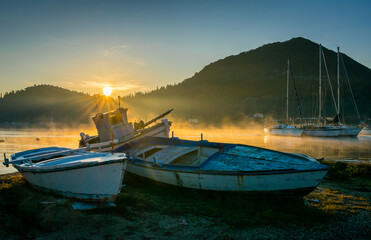 Old fishing boats in sunrise.