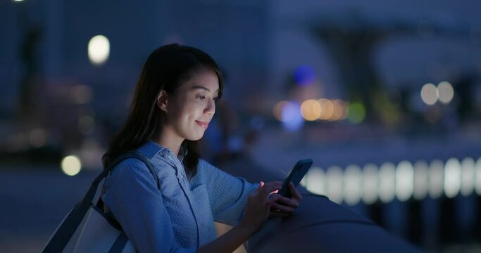 Woman check on smart phone at night
