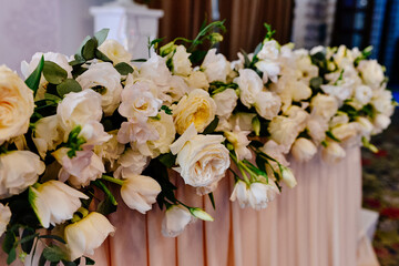 Flower arrangement on the table of the newlyweds