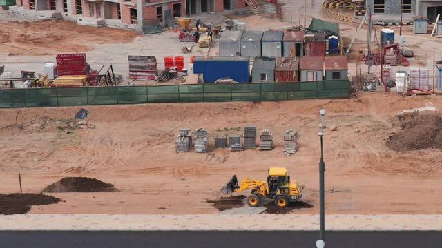 construction of a residential complex in the city, the tractor levels the ground, timelapse.