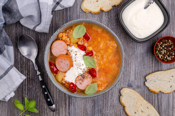 Soup with rice and beans, sausages and vegetables