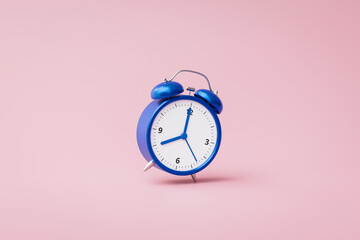 Blue alarm clock ringing on pink background with rush hour concept. Notification to wake up time or...