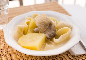 chicken broth soup with chicken, potatoes, and pasta shells