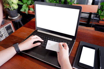 Cropped shot view of business woman’s hands typing the labtop with blank copy space screen for your information content or text message.