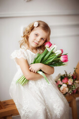 baby girl with tulips in a photo Studio, beautiful interior, spring, March