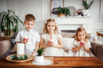 Obraz na płótnie Canvas children eat cupcakes, laugh, very tasty, happiness is, beautiful interior, birthday