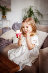 baby girl eats cupcakes, very tasty, happiness is there, beautiful interior