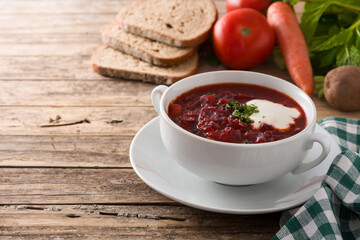 Traditional Ukrainian Russian borsch. Beetroot soup on wooden table. Copy space