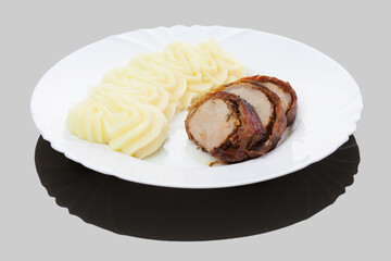 Romanian traditional dish - pork tenderloin wrapped in bacon with mashed potatoes