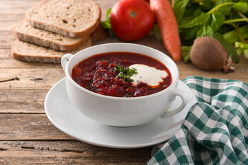 Traditional Ukrainian Russian borsch. Beetroot soup on wooden table