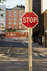 Stop symbol with blurred street of the city on a background.