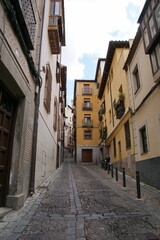 Toledo town street view with historical buildings in Spain.