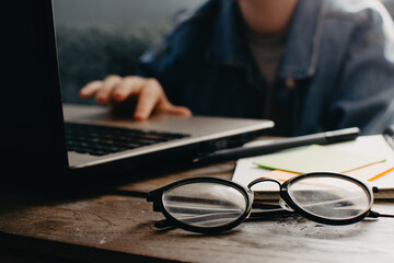 Teenage boy works at desk in his bedroom. School and work concept. Home education. Homework. Home schooling. Working at home. 