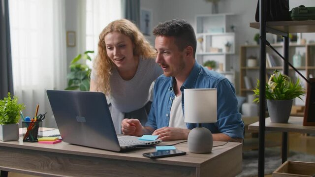 Young businessman discuss with his girlfriend while working on design