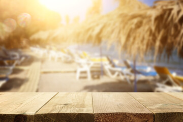 background Image of wooden table in front of tropical beach. Ready for product display