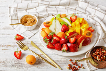 Healthy dessert: fruit platter on a white plate