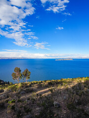 Lake Ticticaca on a sunny day with blue skies and clouds at the horizon