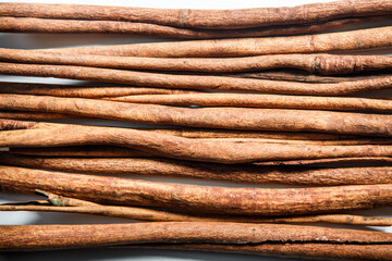 top view closeup group of dry cinnamon sticks served on white table surface