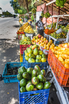 dramatic colourful image of a mango stand on the busy caribbean town street in the dominican republic.